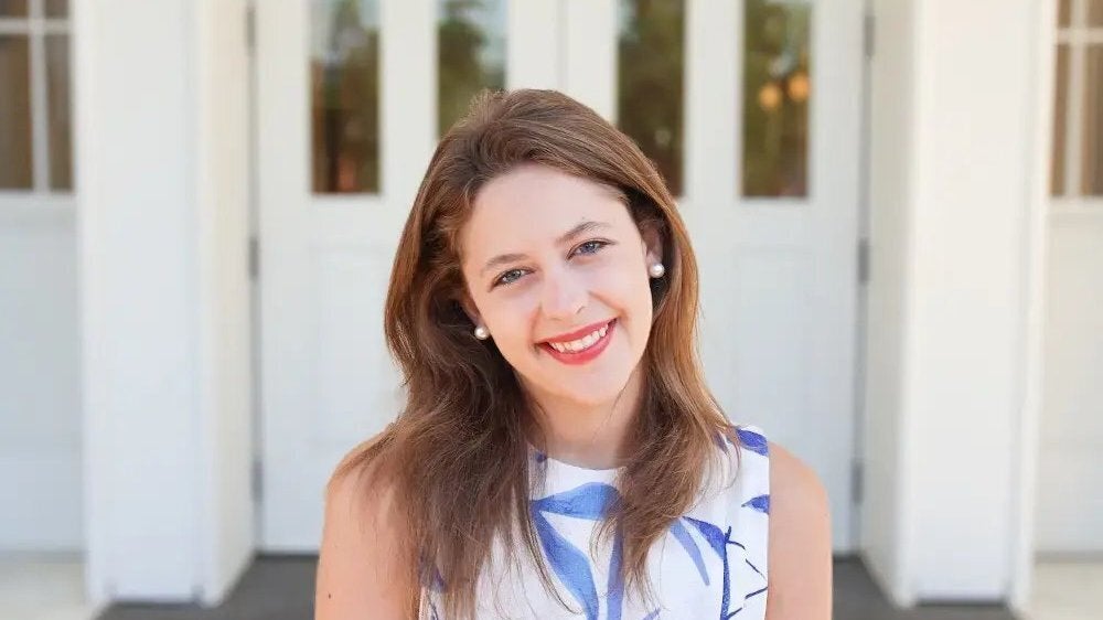 Portrait of student, Samantha Simmons, standing outside of a building on the University of Alabama campus in Tuscaloosa.