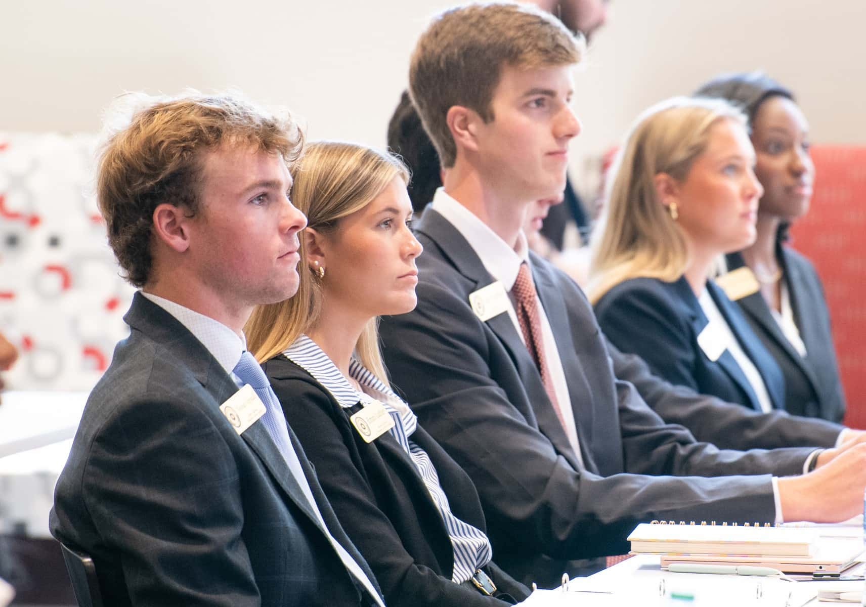 Members of the President's Cabinet Scholars sitting at a table during a meeting