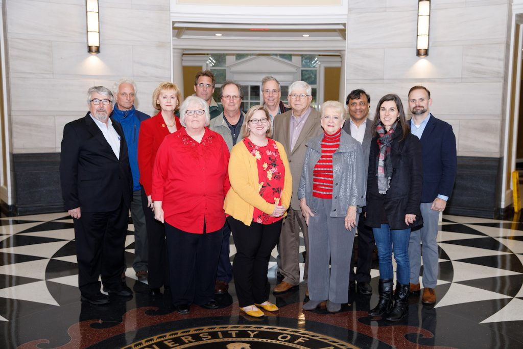Members of the Faculty Senate stand in the Shelby Rotunda