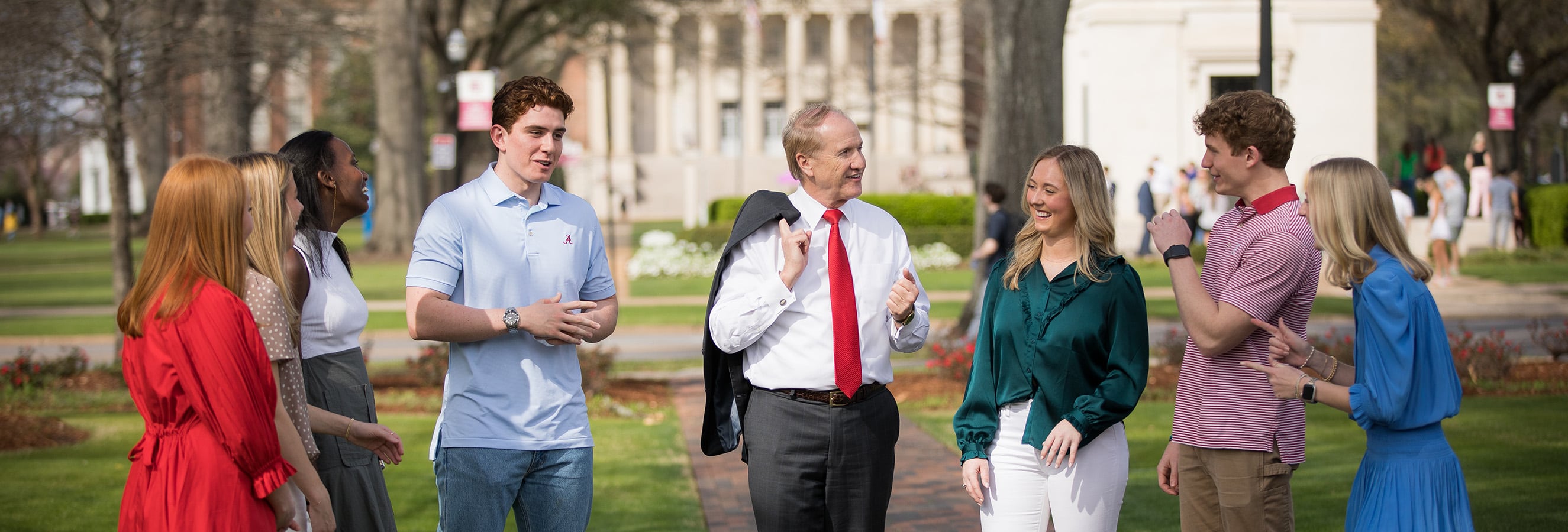 President Bell walks with a group of students